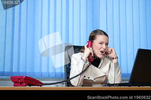 Image of .young businesswoman working on a laptop computer in the office.