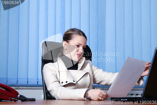 Image of .young businesswoman reading documents