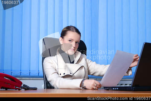 Image of young businesswoman reading 
