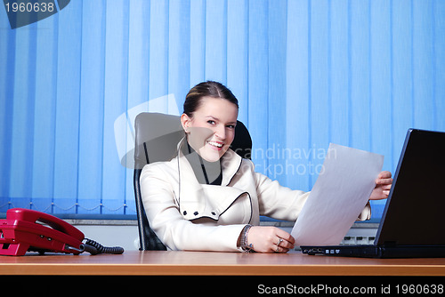 Image of .young businesswoman reading documents