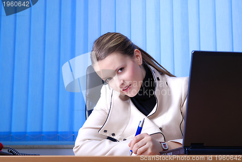 Image of .young businesswoman signing a contract