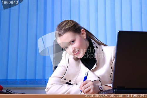 Image of .young businesswoman signing a contract