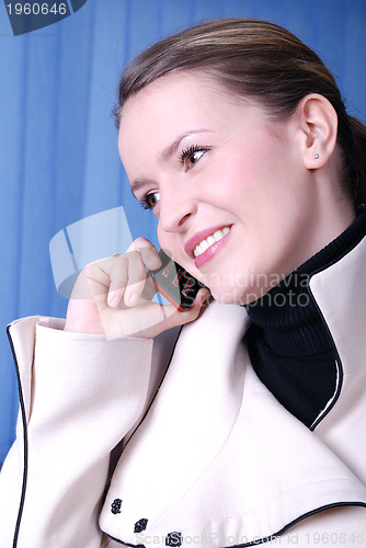Image of a beautiful  business woman on the phone at work