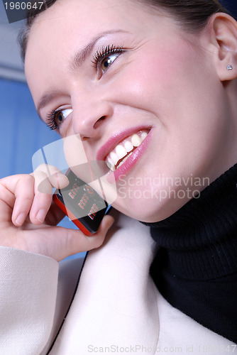 Image of Happy businesswoman with cellphone