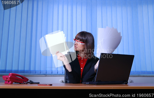 Image of .angry businesswoman holding documents