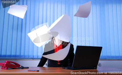 Image of Happy businesswoman throwing documents