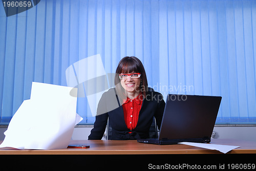 Image of .happy businesswoman throwing papers in air