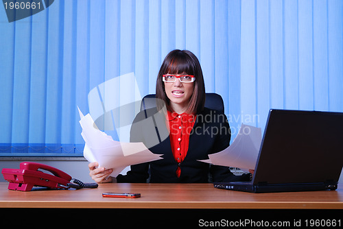 Image of .angry businesswoman holding documents