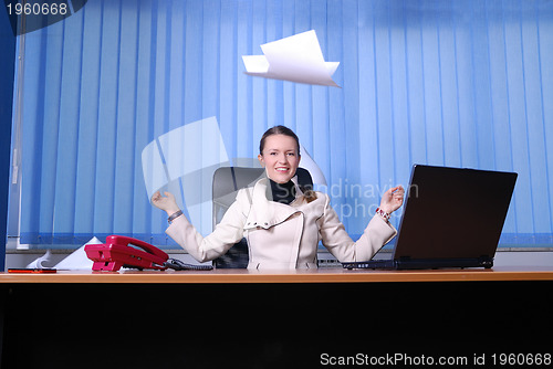 Image of .happy businesswoman throwing papers in air