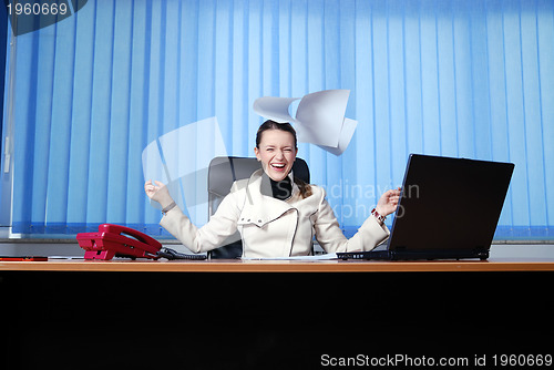 Image of .happy businesswoman throwing papers in air