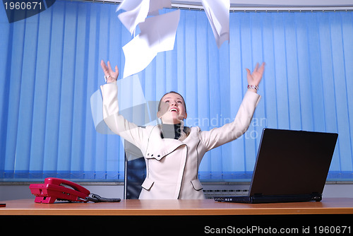 Image of .happy businesswoman throwing papers in air