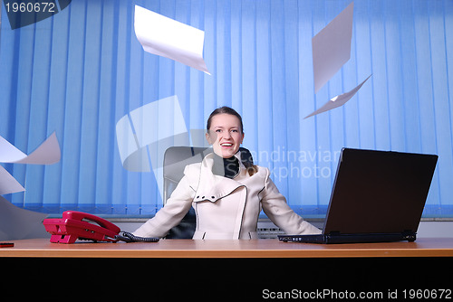 Image of .happy businesswoman throwing papers in air