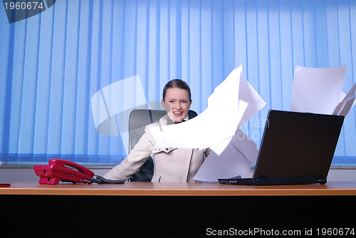 Image of .happy businesswoman throwing papers in air