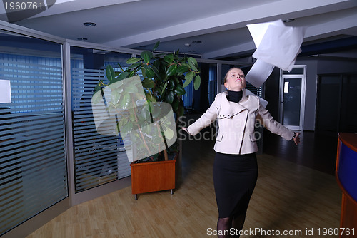 Image of .happy businesswoman throwing documents 