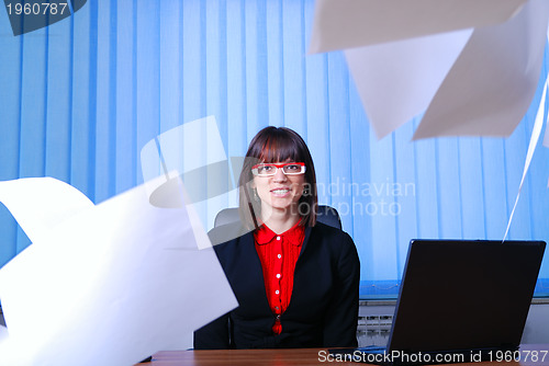 Image of .happy businesswoman throwing papers in air