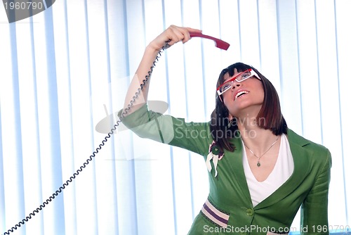 Image of .businesswoman in green suit talking by cellphone