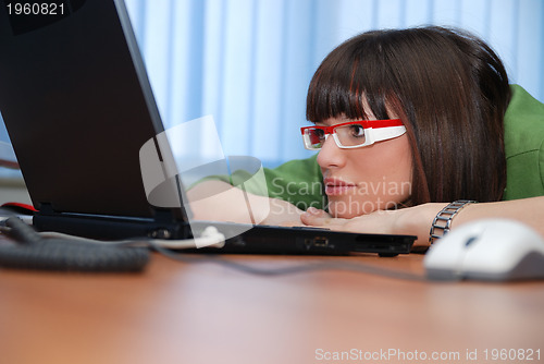 Image of .pretty lady looking at laptop