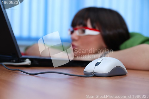 Image of .pretty lady looking at laptop