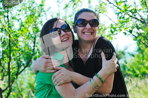 Image of woman pragnant outdoor with friend