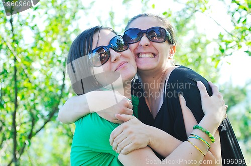 Image of woman pragnant outdoor with friend