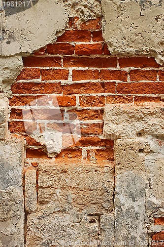 Image of Old brick masonry with destroyed stucco