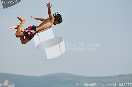 Image of boy jump sea