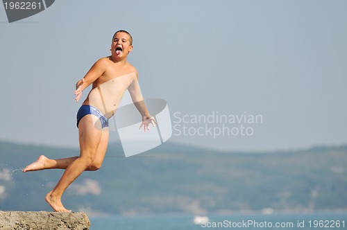 Image of boy jump sea