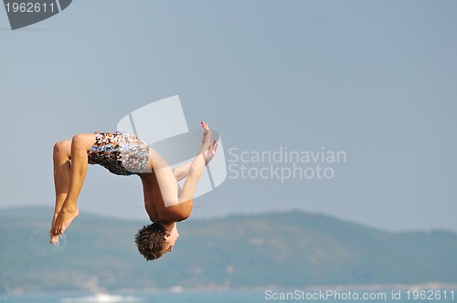 Image of boy jump sea