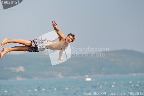 Image of boy jump sea