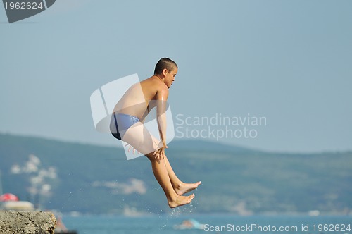 Image of boy jump sea