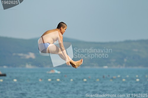 Image of boy jump sea