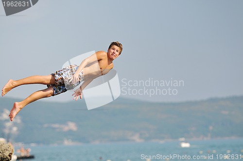 Image of boy jump sea