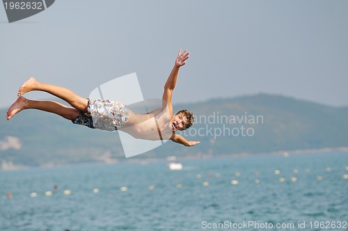 Image of boy jump sea