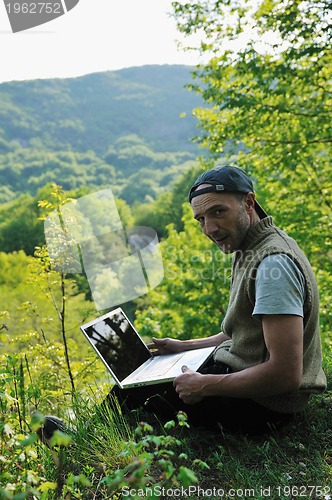 Image of man outdoor laptop