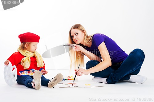 Image of Pretty young mother and daughter drawing