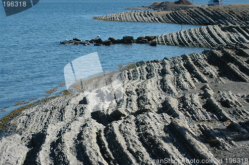 Image of Jagged rock meets water