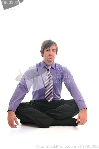 Image of young business man meditating