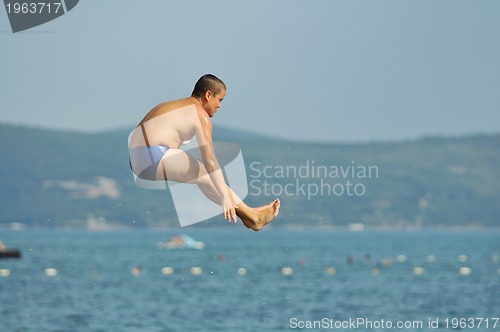 Image of boy jump sea