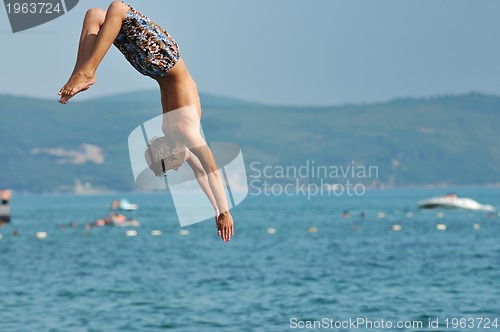 Image of boy jump sea