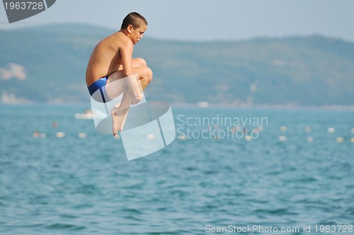 Image of boy jump sea