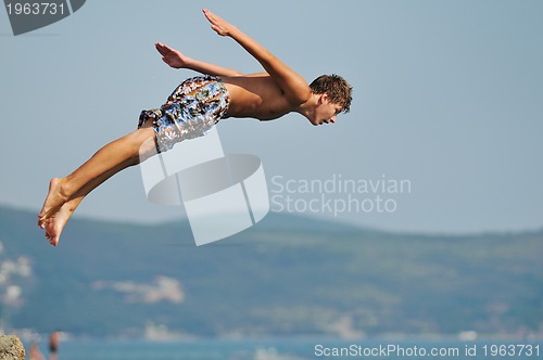 Image of boy jump sea