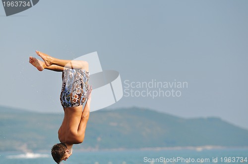 Image of boy jump sea