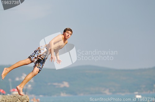 Image of boy jump sea