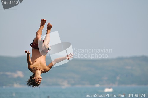Image of boy jump sea