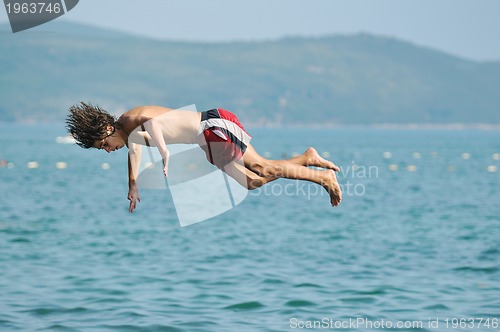 Image of boy jump sea