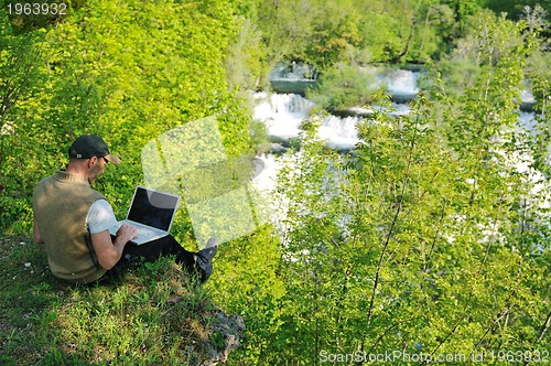 Image of man outdoor laptop