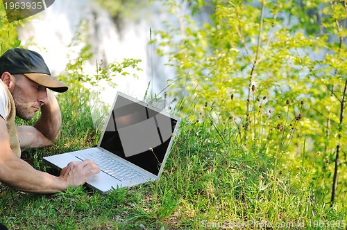 Image of man outdoor laptop