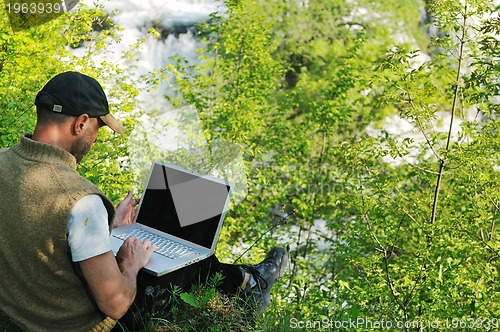 Image of man outdoor laptop