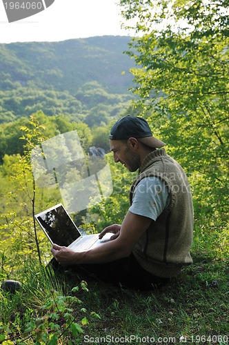 Image of man outdoor laptop