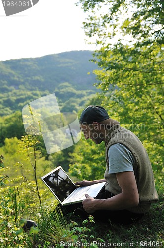 Image of man outdoor laptop